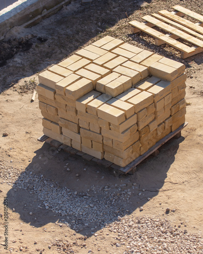 Yellow bricks for building a house on a construction site photo