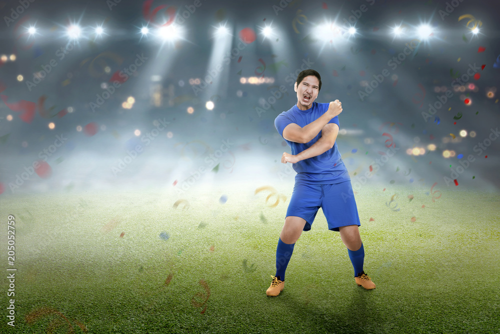Expressive asian footballer after winning the match Expressive asian footballer after winning the match
