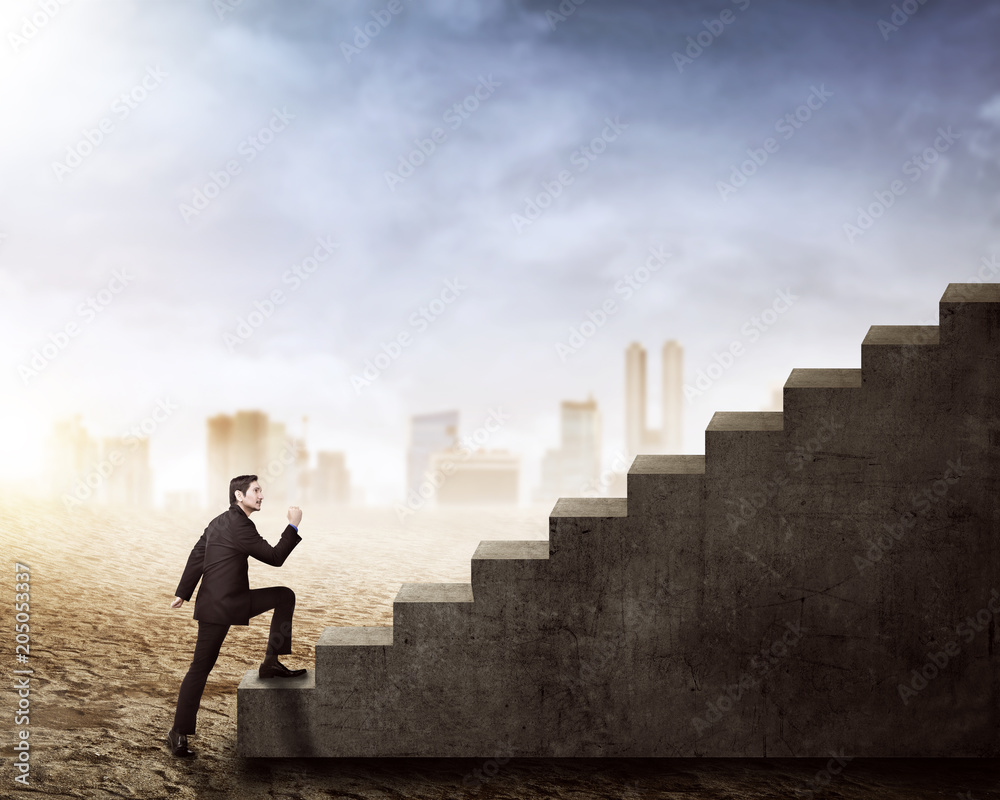 Side view of asian businessman walking up stairs