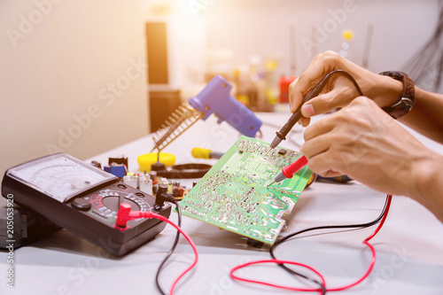 Close up of the hand men hold tool repairs electronics manufacturing Services,Repair of electronic devices, tin soldering parts.