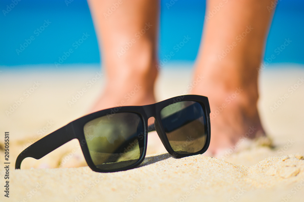 Fashion sunglasses on sea beach. Summer holiday relax background with copy space