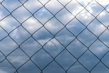 Wire mesh fence (Rabitz net) against the  cloudy sky