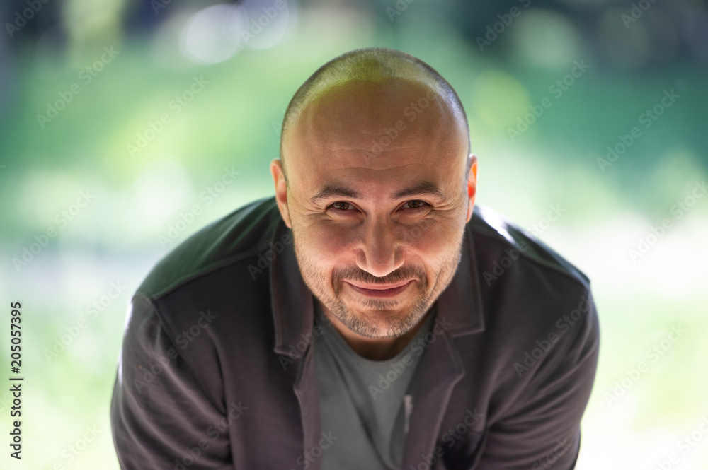 face of a bearded smiling bald man in the park. face of a bearded smiling bald man in the park.