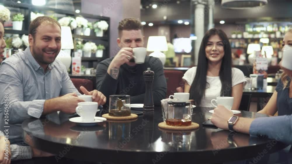 large company of friends at a table in a cafe or restaurant. relaxed communication of friends over dinner large company of friends at a table in a cafe or restaurant. relaxed communication of friends over dinner