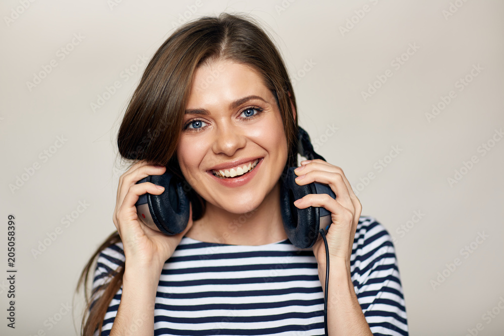 Close up face portrait of smiling woman with earphones on neck. Close up face portrait of smiling woman with earphones on neck.