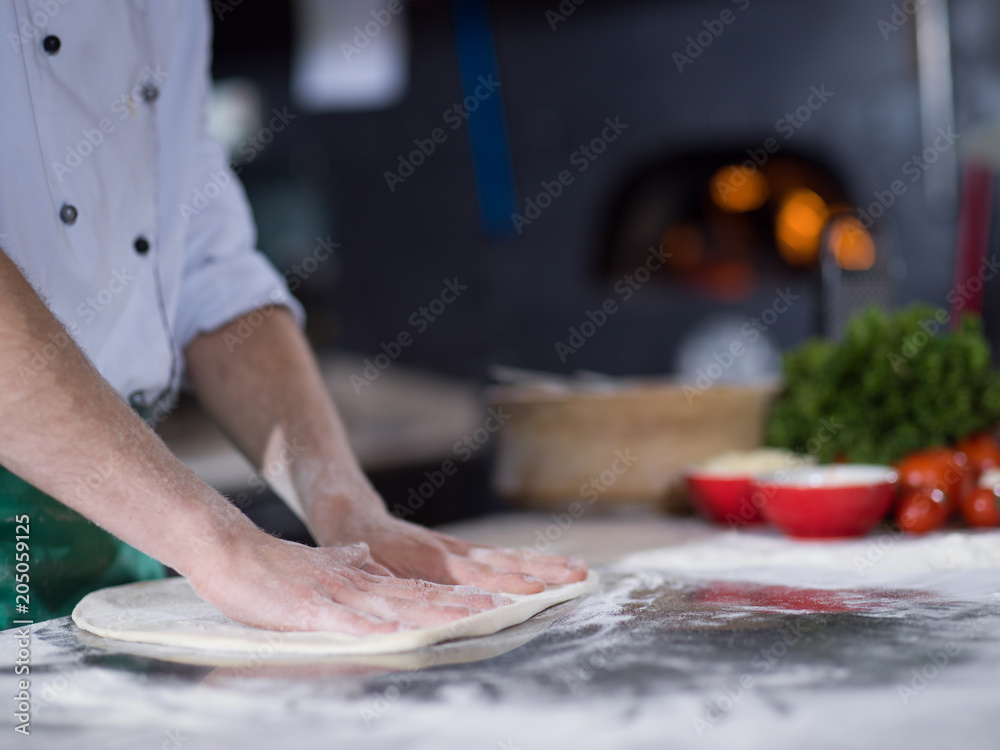 chef preparing dough for pizza