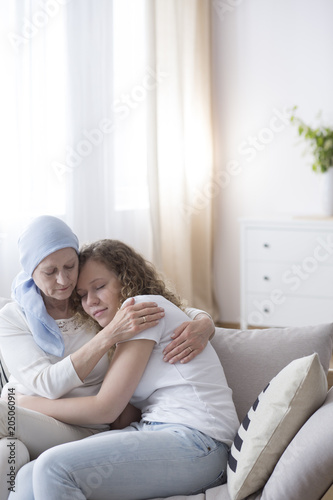 Daughter and sick mother hugging