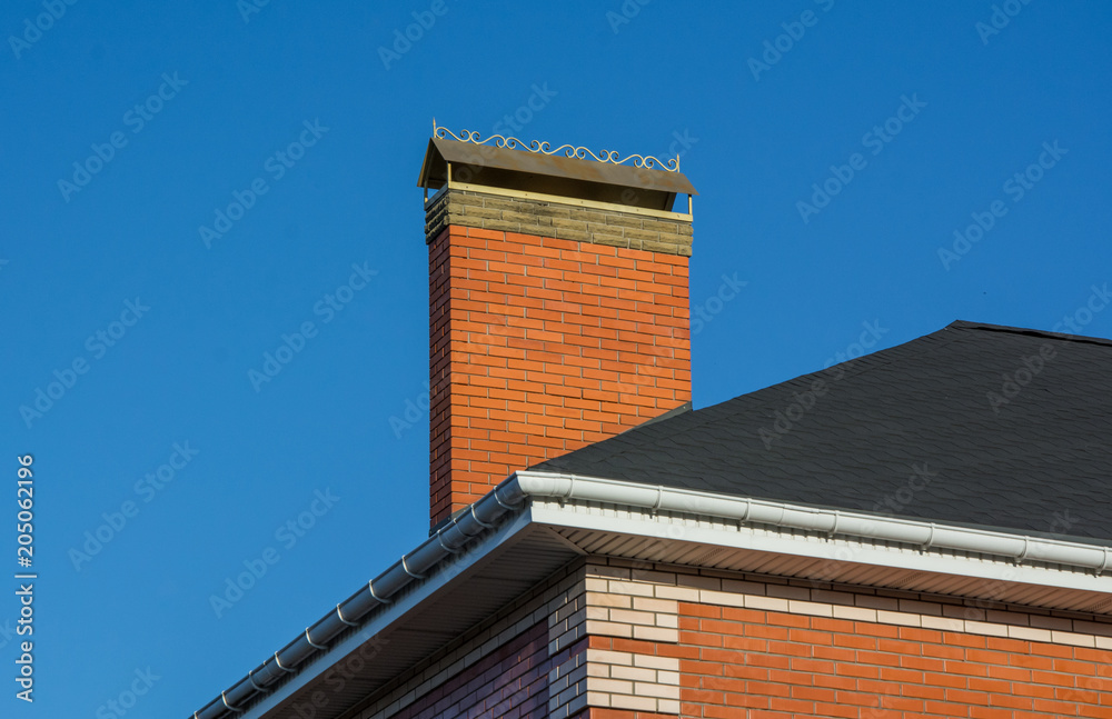 Modern brick chimney on the roof