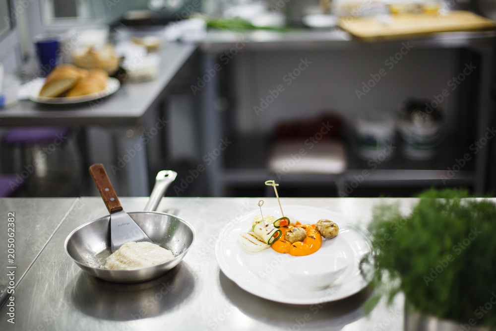 fried fish in a frying pan before serving fried fish in a frying pan before serving