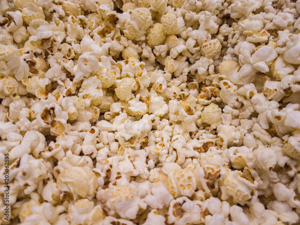 Scattered salted popcorn, texture background.