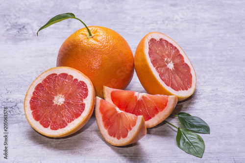 Grapefruit whole, half and slice, green leaf, juicy ripe isolated on a gray background photo