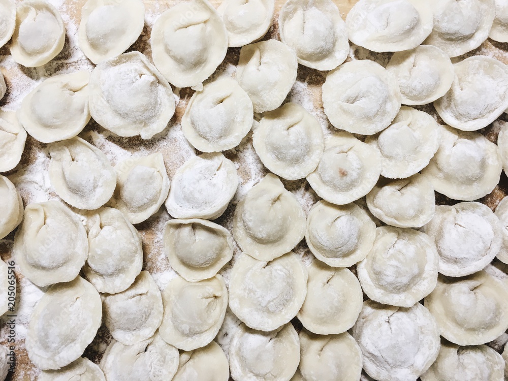 Freshly cooked dumplings lying on a wooden board. Phone photography.
Freshly cooked dumplings lying on a wooden board. Phone photography.