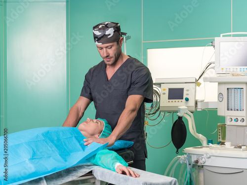 Young surgeon and his patient in operatory room before surgery.