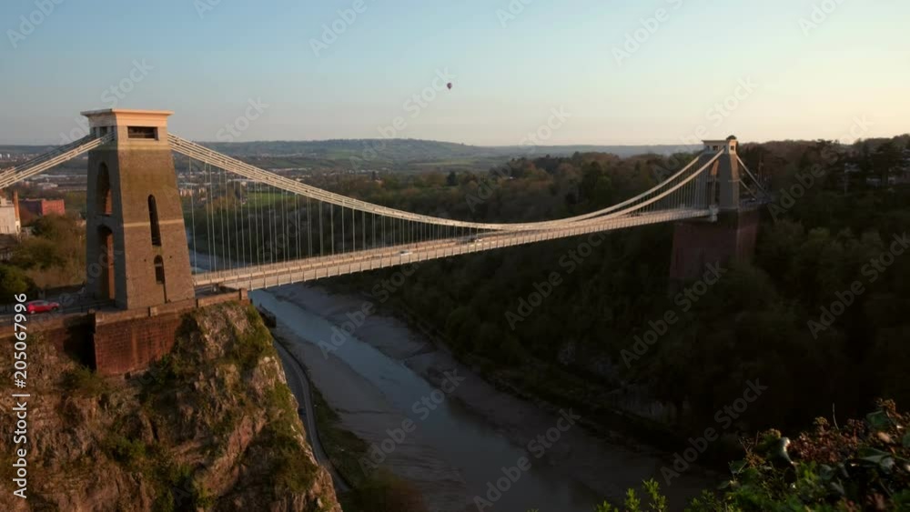 Static clip of the Clifton Suspension Bridge during a beautiful sunset. A hot air ballon is in the sky Static clip of the Clifton Suspension Bridge during a beautiful sunset. A hot air ballon is in the sky