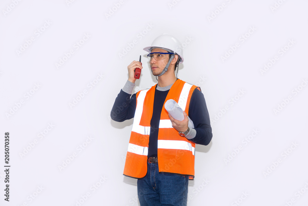 Asian engineer wearing safety helmet and safety glasses holding blueprints on white background