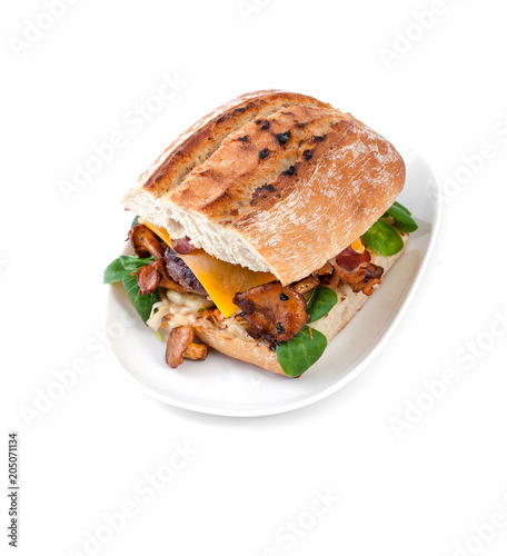 Burger with beef chop and mushrooms chanterelles on an oval plate on a white background.