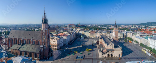 Aerial panorama of Krakow old city, Poland. Main Market Square (Rynek), old cloth hall (Sukiennice), town hall tower, St. Mary church (Mariacki), renovated Mickiewicz statue and far view of Wawel