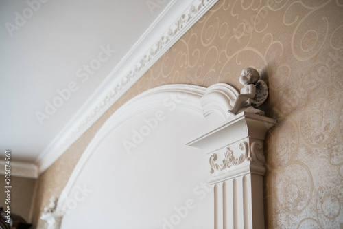 Fotografia White column with portico decorative elements, classic interior fragment