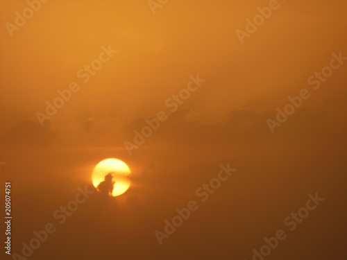 Abstract sunset scenic view golden red sky with clouds passing through the sun