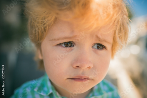 Frustration  child emotions. A sad child looks into the distance. Beautiful face. Cute boy. Sadness and tears  disappointment  childhood experiences. Face close-up portrait  children