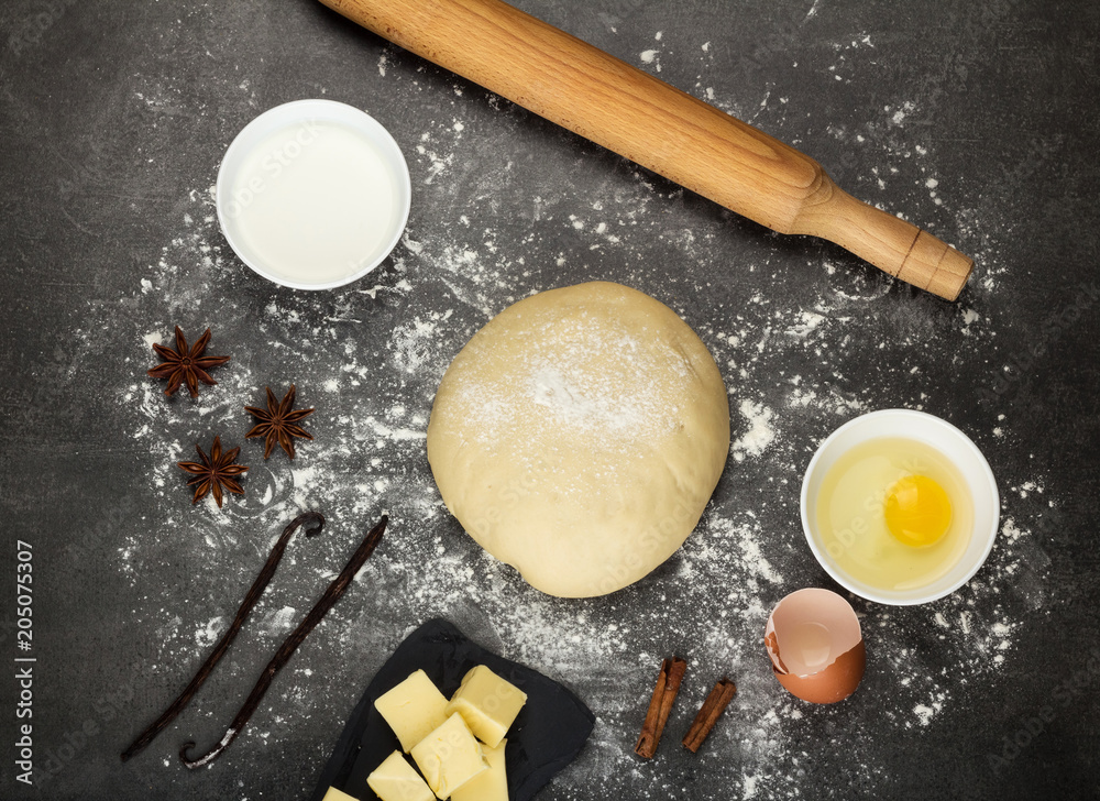 Finished dough, remaining products and rolling pin on work surface Finished dough, remaining products and rolling pin on work surface