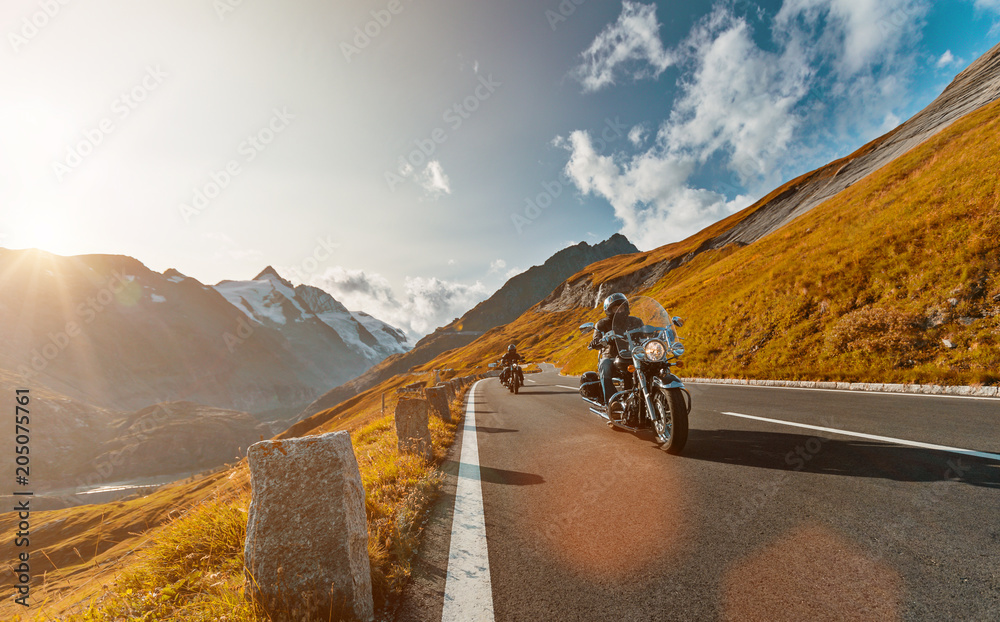 Naklejka premium Motorcycle driver riding japanese high power cruiser in Alpine highway on famous Hochalpenstrasse, Austria.
