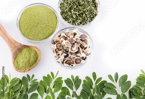 Seeds, leaves and moringa powder. White background - Moringa oleifera