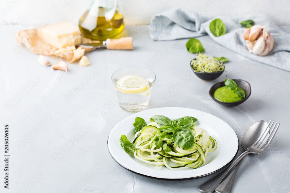 Seasonal zucchini spaghetti pasta noodles with spinach pesto sauce