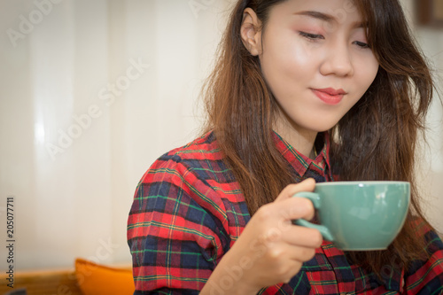 Young woman drinking coffee  in a coffee shop.