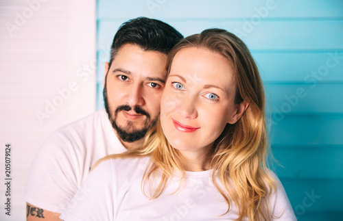 Portrait of smiling happy hipster couple.Bright emotional people in love.Studio shooting