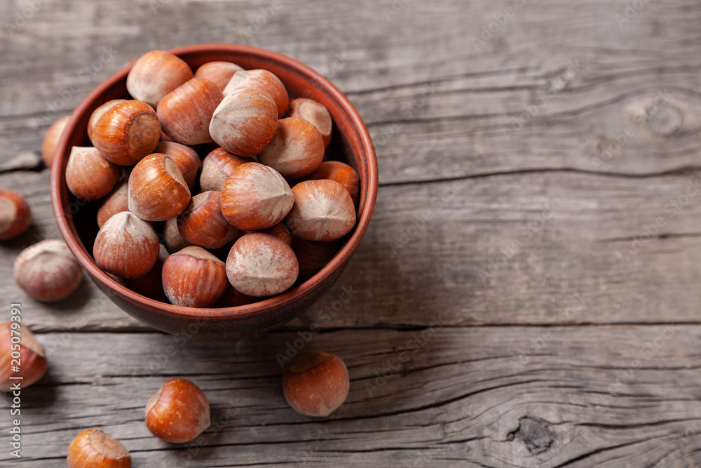 Hazelnut to plate on an old wooden table.. Copy space for text Hazelnut to plate on an old wooden table.. Copy space for text
