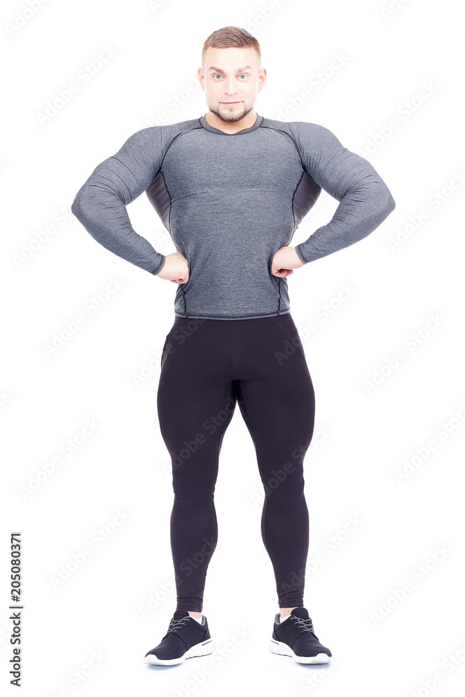 Portrait of young confident bodybuilder or gym instructor posing on white background Portrait of young confident bodybuilder or gym instructor posing on white background