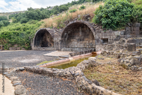 Ritual  arch in ruins of ancient Jewish settlement Umm el Kanatir - Mother Arches on the Golan Heights photo