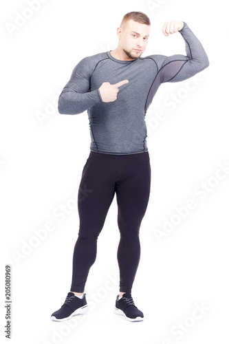 Portrait of young confident bodybuilder or gym instructor posing on white background