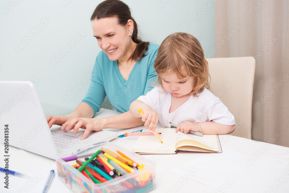 A mother working at home and parenting her child.