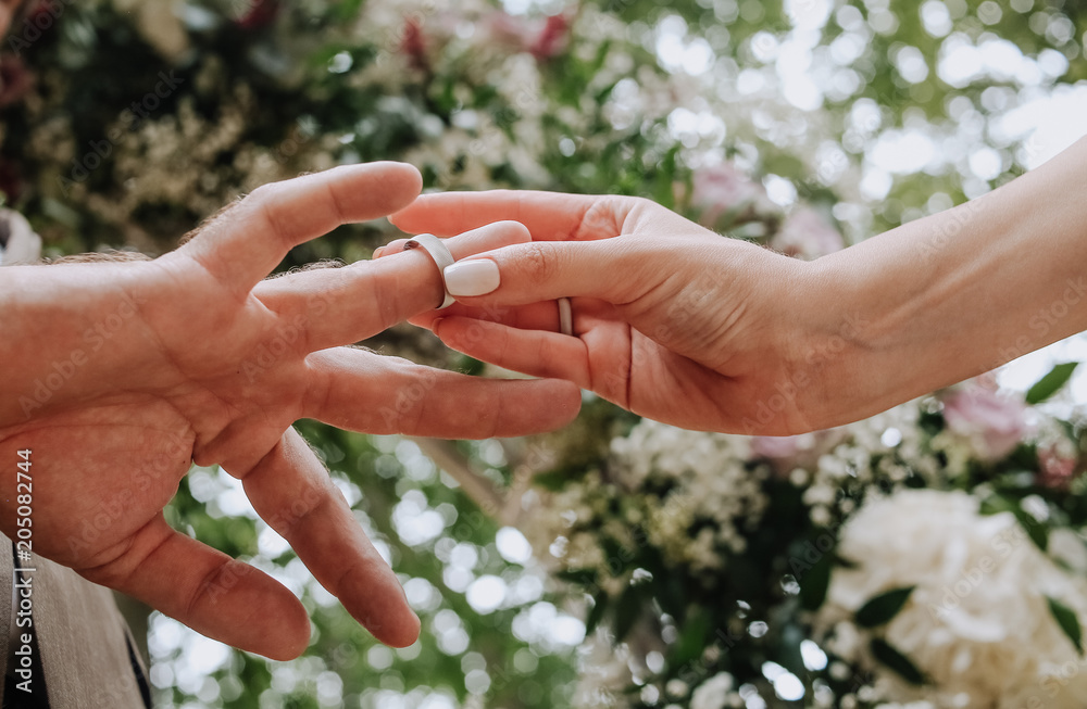 bride puts ring grooms finger ceremony