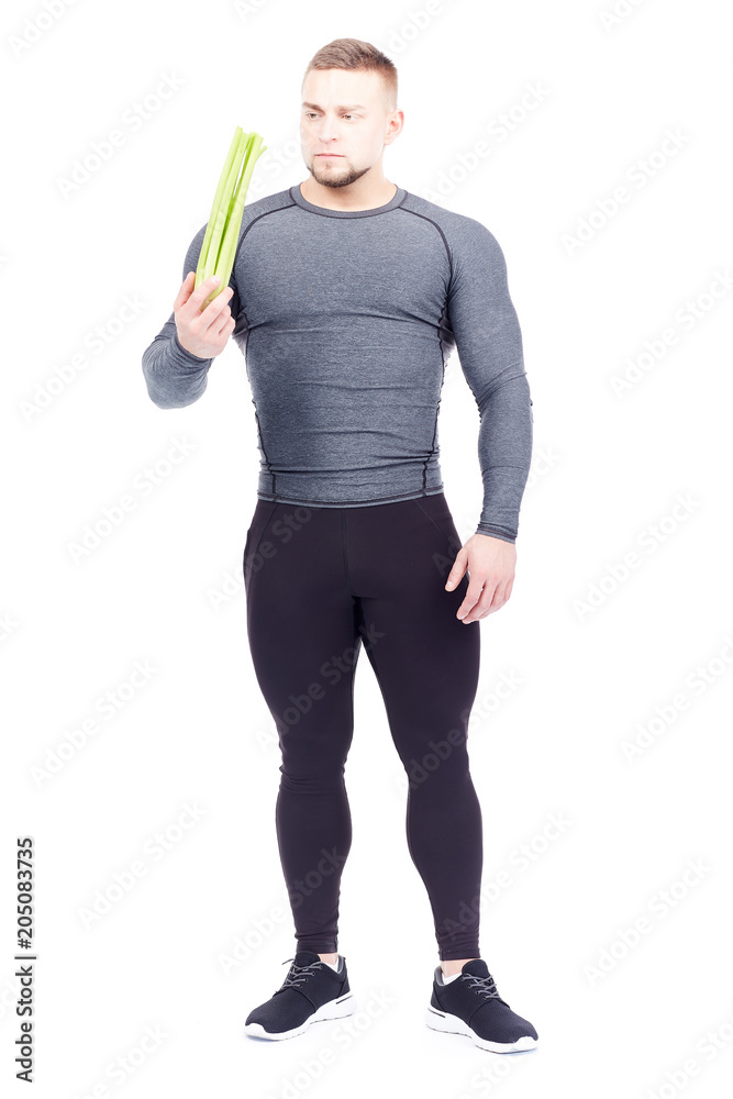Portrait of handsome sporty man holding fresh celery isolated on white Portrait of handsome sporty man holding fresh celery isolated on white