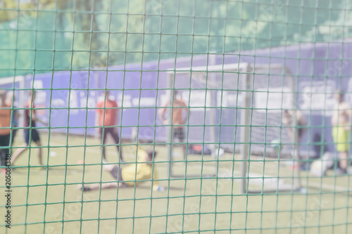 Fight for a soccer ball at the sports gate. Football training on sports field. Sportsmen, football players on training. Football outdoor stadium. Blurred image photo