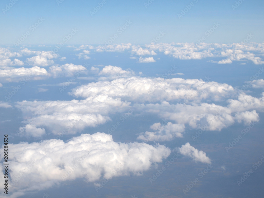 Blue sky with clouds, a view from airplane window Blue sky with clouds, a view from airplane window