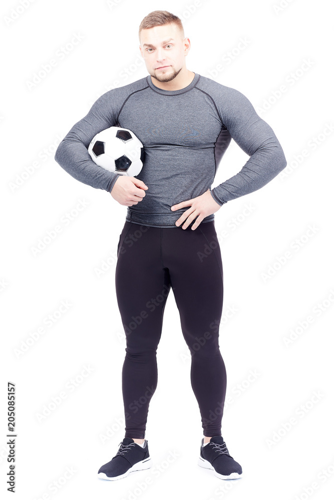 Isolated portrait of well-muscled male athlete holding soccer ball