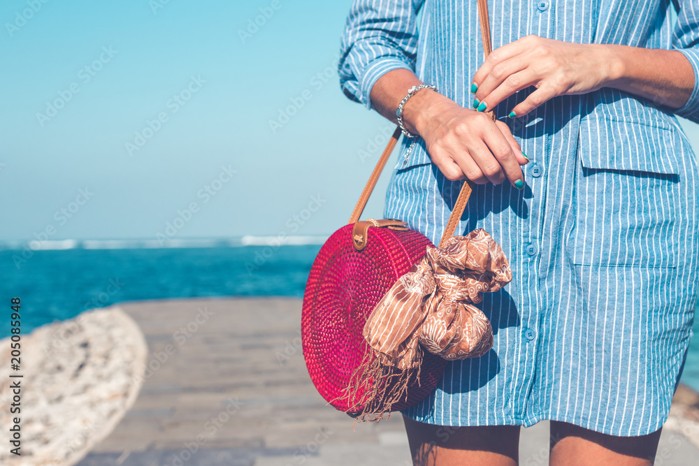 Woman hands with fashionable stylish nude rattan bag outside. Tropical  island of Bali, Indonesia. Rattan and silk. Stock Photo | Adobe Stock
