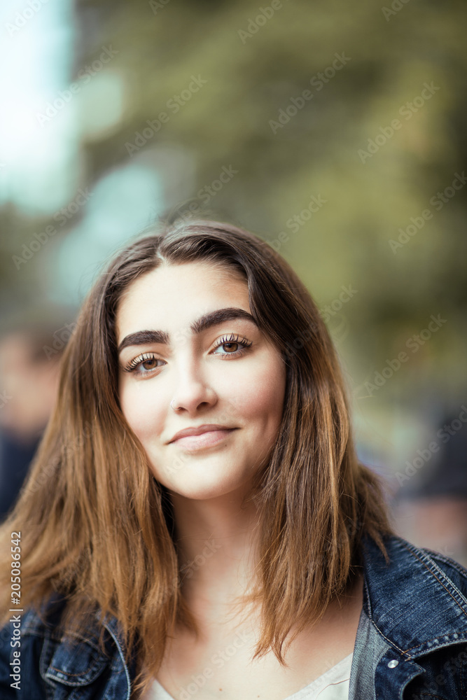 beautiful young woman, outside in a park in the sunlight, happy smiling, lifestyle concept shoot