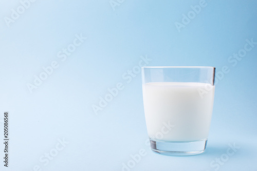 Milk in a glass on a blue background
