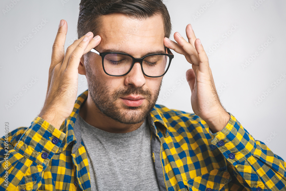 People, crisis, emotions and stress concept - unhappy man suffering from head ache at home. White background. People, crisis, emotions and stress concept - unhappy man suffering from head ache at home. White background.