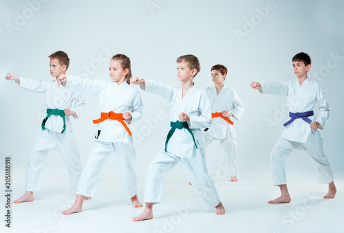 The group of boys and girl fighting at Aikido training in martial arts school. Healthy lifestyle and sports concept