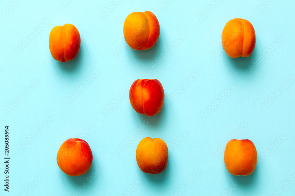 Naklejka Apricots set of six isolated over a blue background viewed from above, flatlay style