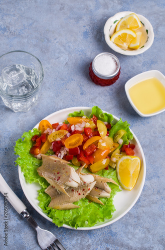 Fish fillet with raw vegetables photo