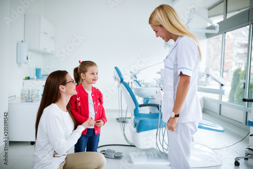 Dentist with sterile mask and dental instruments held exam teeth of patient