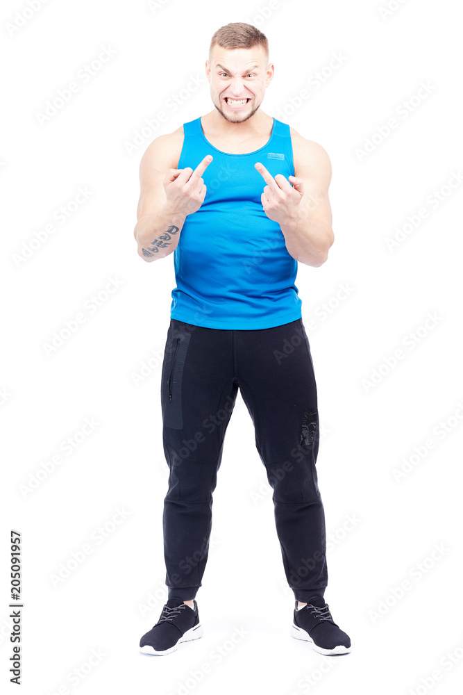 Portrait of well-muscled man giving middle finger at camera Portrait of well-muscled man giving middle finger at camera