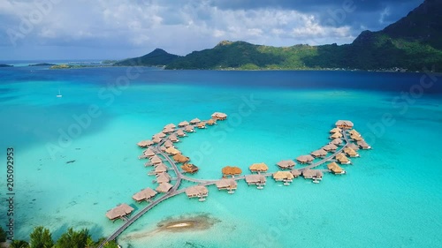 Aerial view of tropical paradise of Bora Bora, turquoise crystal clear water of scenic lagoon, typical overwater bungalows - South Pacific Ocean, French Polynesia, 4k UHD photo